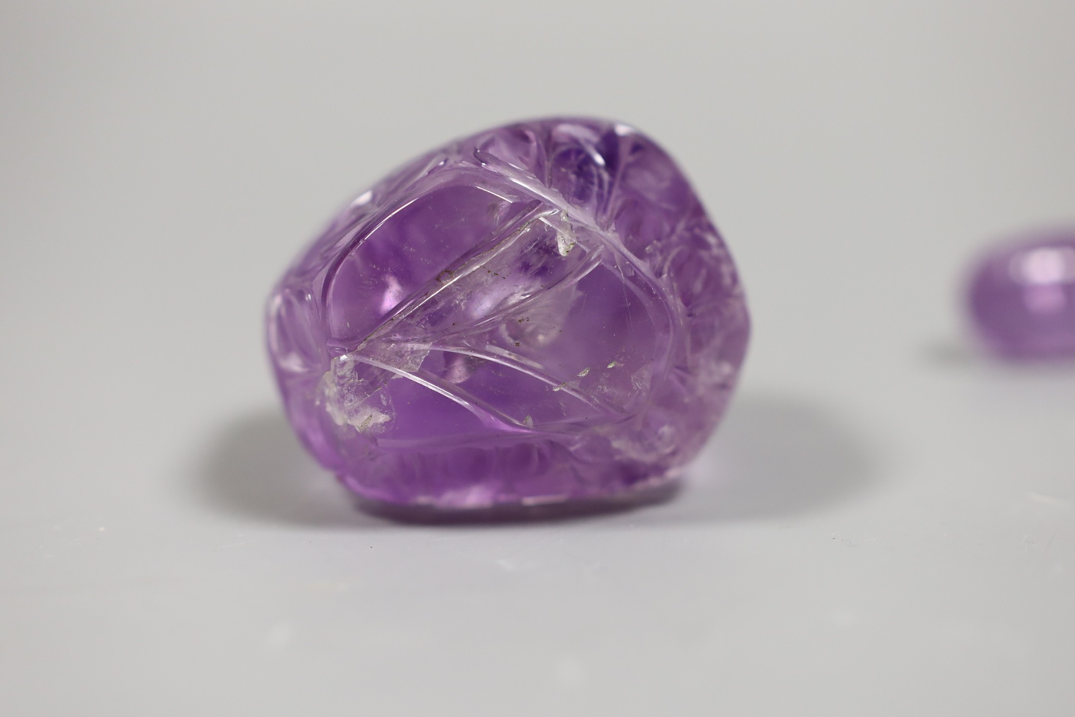 A carved amethyst quartz scent bottle and stopper, 9.5 cms high